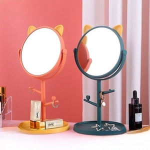 Detail of cat-ear desktop vanity mirrors with branch-shaped jewelry hangers and tray