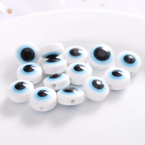 Macro shot of white resin evil eye flat round beads for DIY jewelry making accessories