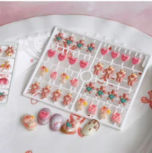 3D resin heart and bear nail art charms with Love engraving on a white carrier