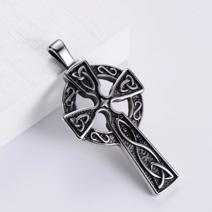 Vintage Gothic Celtic knot cross pendant in silver stainless steel on white pedestal