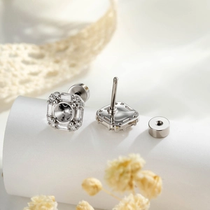 Square silver titanium steel screw back earrings with sparkling zircon on silk background
