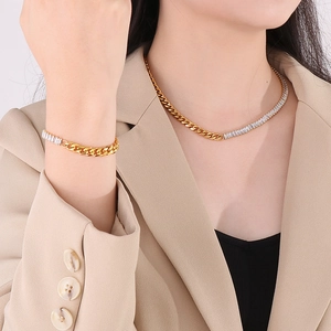 Golden Cuban chain necklace and bracelet set with diamond accents on a female model