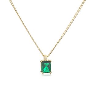 Macro shot of 18K gold plated necklace with emerald green zircon and diamond accents
