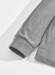 Detail of grey corduroy polo sweatshirt showing ribbed cuffs and textured fabric material