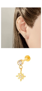 Macro detail of star-shaped titanium labret stud with inlaid zircons and flat back post