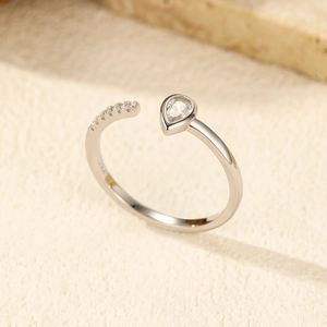 Polished S925 sterling silver open ring featuring a pear-cut stone and pavé accents