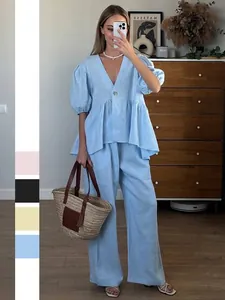 Women's light blue two-piece linen set with puff sleeve V-neck top and wide-leg trousers