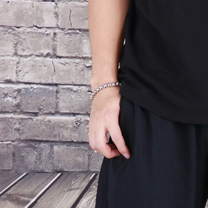 Men wearing a street style silver stainless steel square pearl chain bracelet on wrist