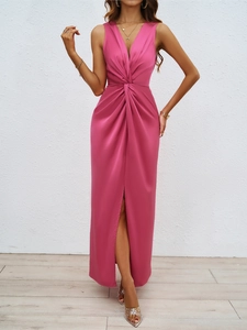 Detailed view of the elegant knot pleats and high slit on a rose red satin dress
