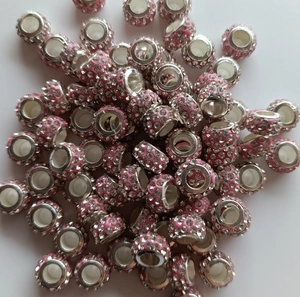 Close-up of pink clay beads with silver metal core and sparkling rhinestones