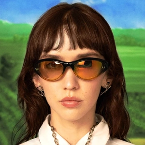 Y2K punk style wraparound sunglasses with orange lenses and black frame for sports