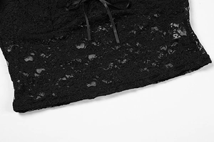 Close-up of black floral lace hem featuring a delicate ribbon bow on an elegant top