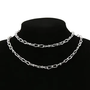 Men's silver bowknot link chain necklace in stainless steel on a black jewelry bust