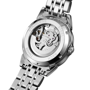 Macro view of skeleton case back revealing mechanical movement of the steel watch