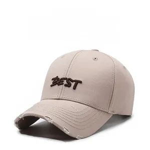 Close-up of BEST embroidery and distressed brim details on khaki cotton baseball cap