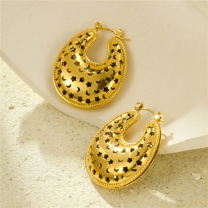 Detailed close-up of golden U-shaped earrings with hollowed star and moon patterns