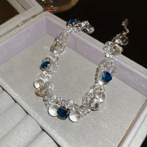Detailed macro view of blue heart crystals and clear beads on a silver-tone necklace