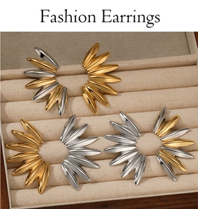 Three-color geometric fan earrings in gold and silver finish on velvet display
