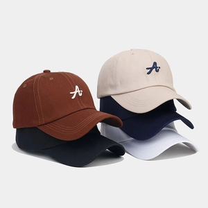 Five assorted cotton baseball caps with 3D embroidery on a clean grey background