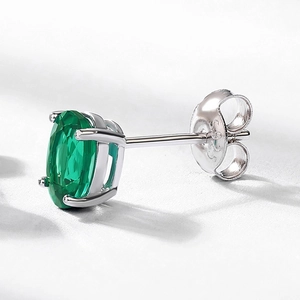 Oval emerald stud earring in 925 silver claw setting with a classic minimalist design
