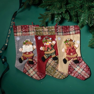 Three Christmas stockings with Santa, Snowman, and Reindeer motifs on a green background