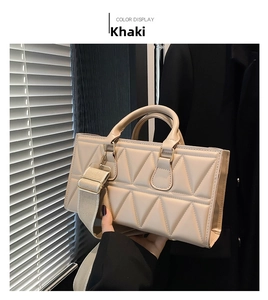 Detail view of khaki crossbody bag featuring triangle quilted texture and wide fabric strap