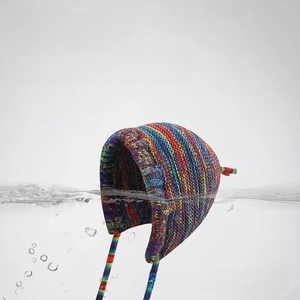 Macro shot of colorful striped knit beanie submerged in water showing washable fabric