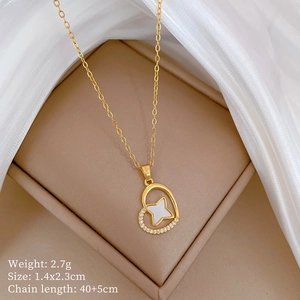 Detailed view of gold heart necklace with mother of pearl and zircon in jewelry box