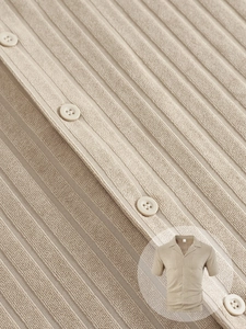 Detail of ribbed knit texture and button-up collar on a men's khaki short sleeve shirt