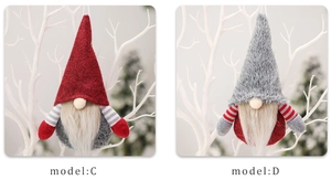 Detail view of hanging Christmas gnomes in red and grey knit hats on white branches