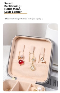 Detail of portable gray velvet jewelry box with necklace hooks and multi-grid storage slots