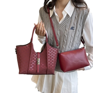 Burgundy faux leather tote and crossbody bag set with stylish monogram embossed patterns