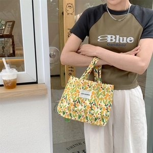Détail d'un sac en toile fleuri avec tulipes jaunes et étiquette LOVE SOZAKKA brodée