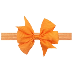 Orange infant headband with a large ribbed bow on a high elasticity soft fabric band