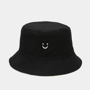 Black cotton bucket hat with white smiley face embroidery for street fashion style
