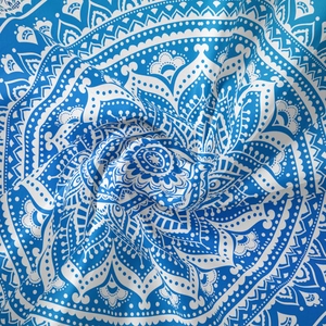 Artistic vortex display of blue and white mandala bohemian tapestry fabric texture
