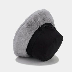 Detail of grey faux fur brim and black ribbon bow on a winter bucket hat for women