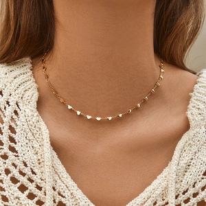 Minimalist 18K gold plated copper necklace with dainty heart charms on a female model