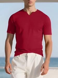 Close-up of men's red V-neck stretch sports T-shirt styled on a beach setting