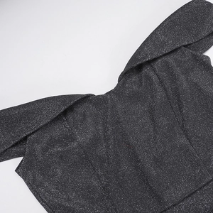 Close-up detail of off-the-shoulder neckline on dark grey sequin glitter dress fabric
