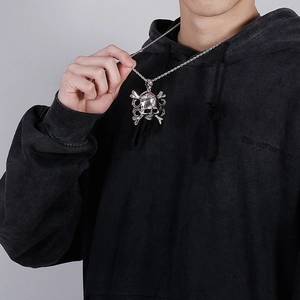 Detailed view of men's vintage skull pendant in silver steel worn with a twisted rope chain