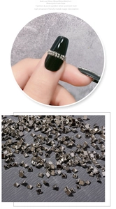 Macro detail of silver pyramid metal studs for punk style nail art and finger display