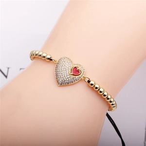 Gold beaded bracelet with micro-pave heart pendant and red heart inlay for women