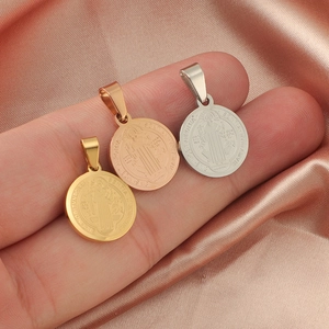 Detailed view of geometric round titanium steel pendants in gold, silver and rose gold finishes