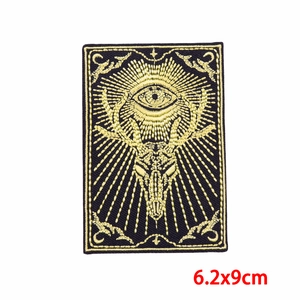 Macro detail of tarot skull embroidery patch with golden eye of providence, 6.2x9cm size