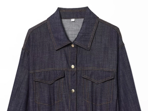 Detailed view of dark blue denim dress collar with metal buttons and yellow stitching
