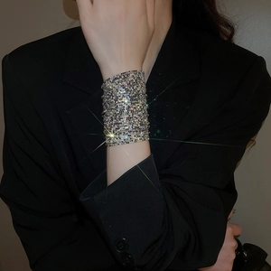 Close-up of wide sparkling multi-layer rhinestone bracelet worn on a female wrist