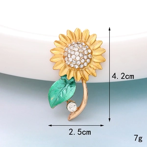 Golden sunflower brooch with white crystals and green enamel leaves, size 4.2cm by 2.5cm