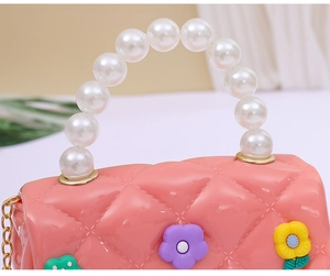 Pink jelly crossbody bag for girls with pearl handle, diamond pattern, and floral charms