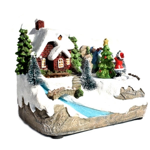 Maison de Noël enneigée lumineuse avec musique, sapins et pont décoratif